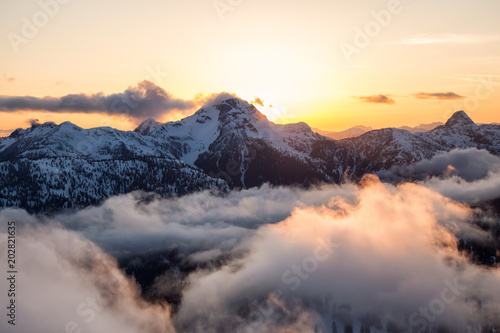 Striking and beautiful aerial landscape view of Canadian Mountains during a vibrant sunsetd. Taken North of Vancouver  British Columbia  Canada.