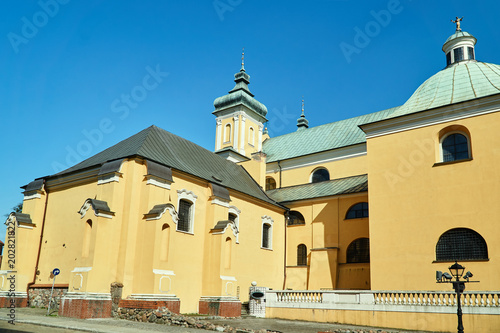 buildings of a monastery and a church with a belfry in Poznań.