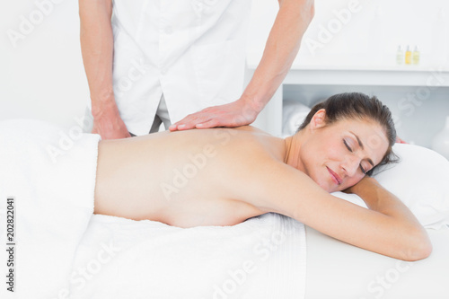 Male physiotherapist massaging womans back