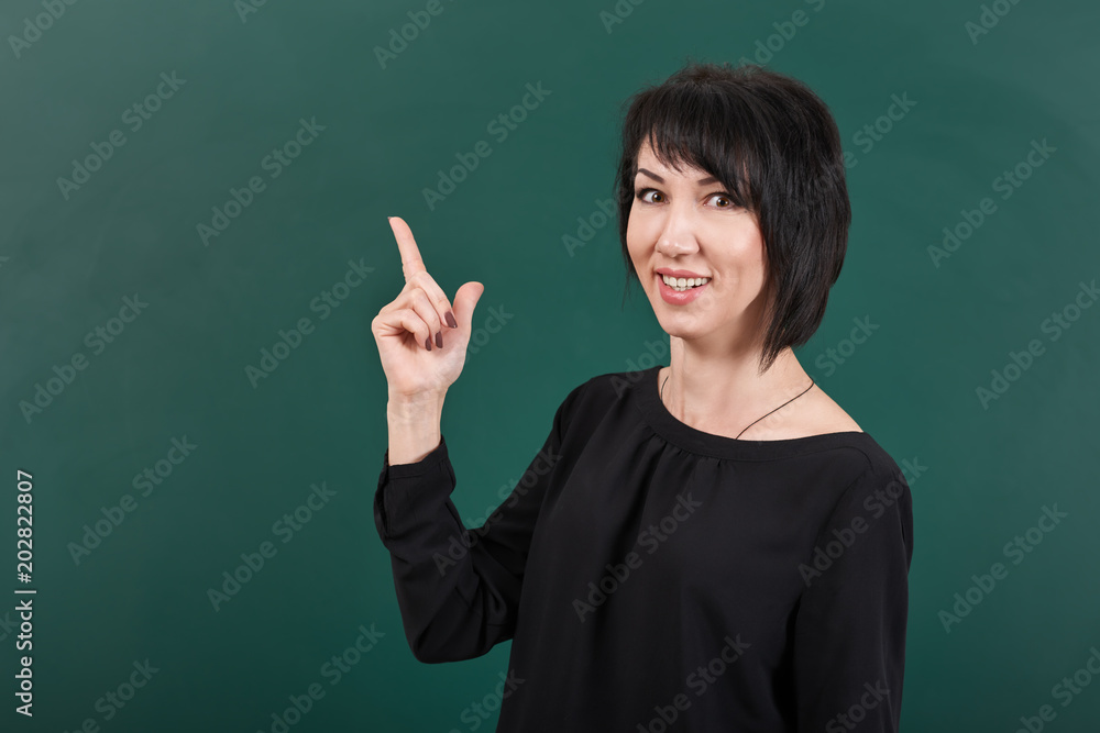 teacher having idea and posing by chalk Board, learning concept, green background, Studio shot teacher having idea and posing by chalk Board, learning concept, green background, Studio shot