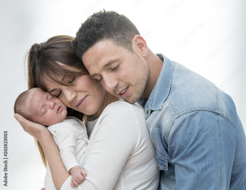Young Couple Posing Happy with their first child Young Couple Posing Happy with their first child