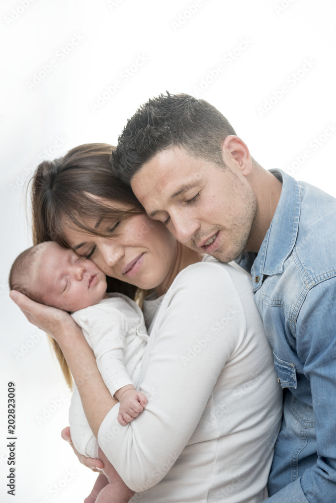 Young Couple Posing Happy with their first child Young Couple Posing Happy with their first child