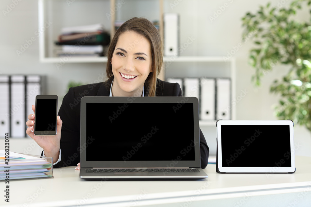 Office worker showing multiple device blank screens Office worker showing multiple device blank screens