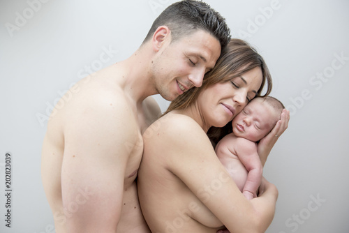 Young Couple Posing Happy with their first child