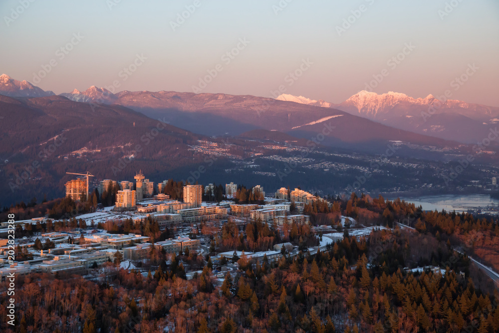 Aerial view of Burnaby Mountain and University Campus. Taken in Vancouver, British Columbia, Canada, during a vibrant winter sunset.