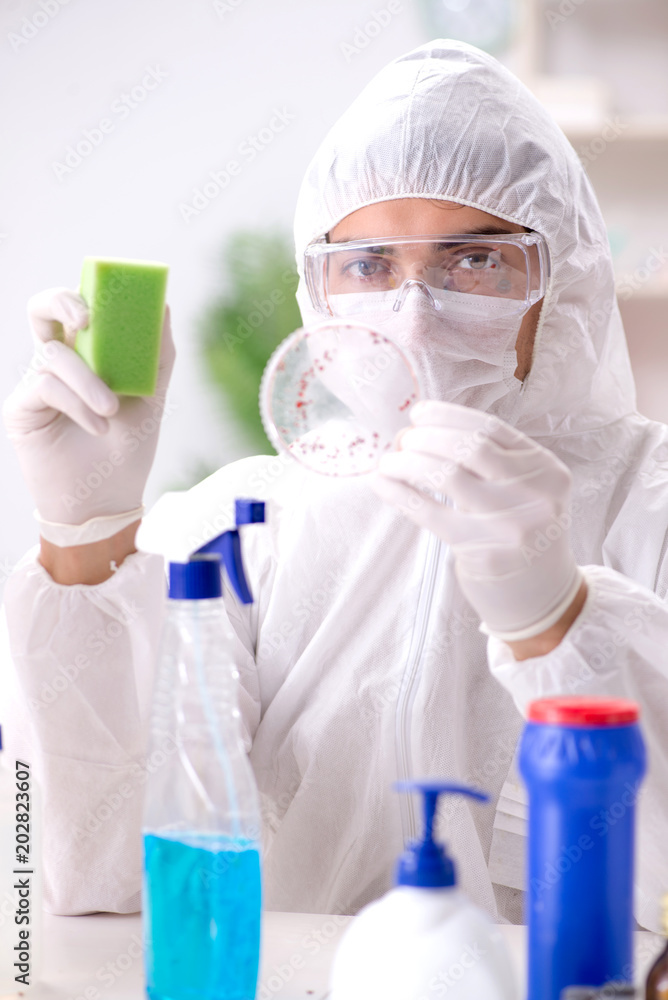 Chemist checking the quality of bathroom supplies Chemist checking the quality of bathroom supplies