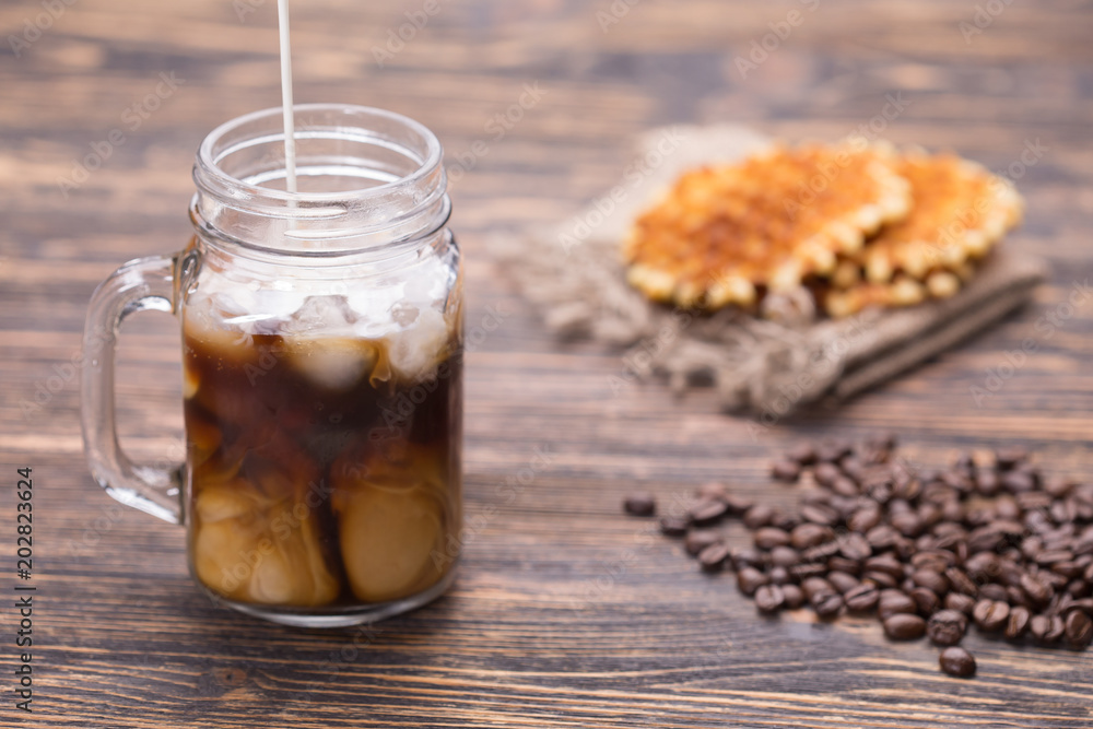 Milk is poured into coffee Milk is poured into coffee