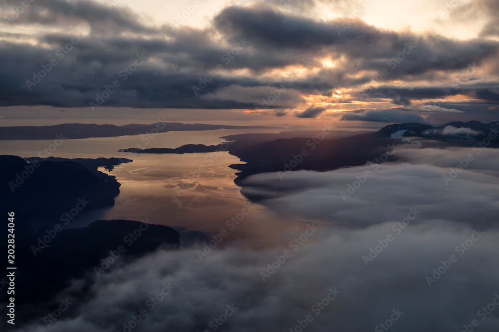 Aerial landscape view of Sunshine Coast during a vibrant and dramatic sunset. Taken Northwest of Vancouver, British Columbia, Canada.