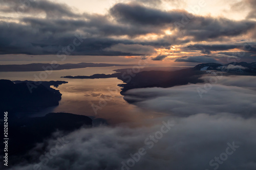 Aerial landscape view of Sunshine Coast during a vibrant and dramatic sunset. Taken Northwest of Vancouver, British Columbia, Canada.