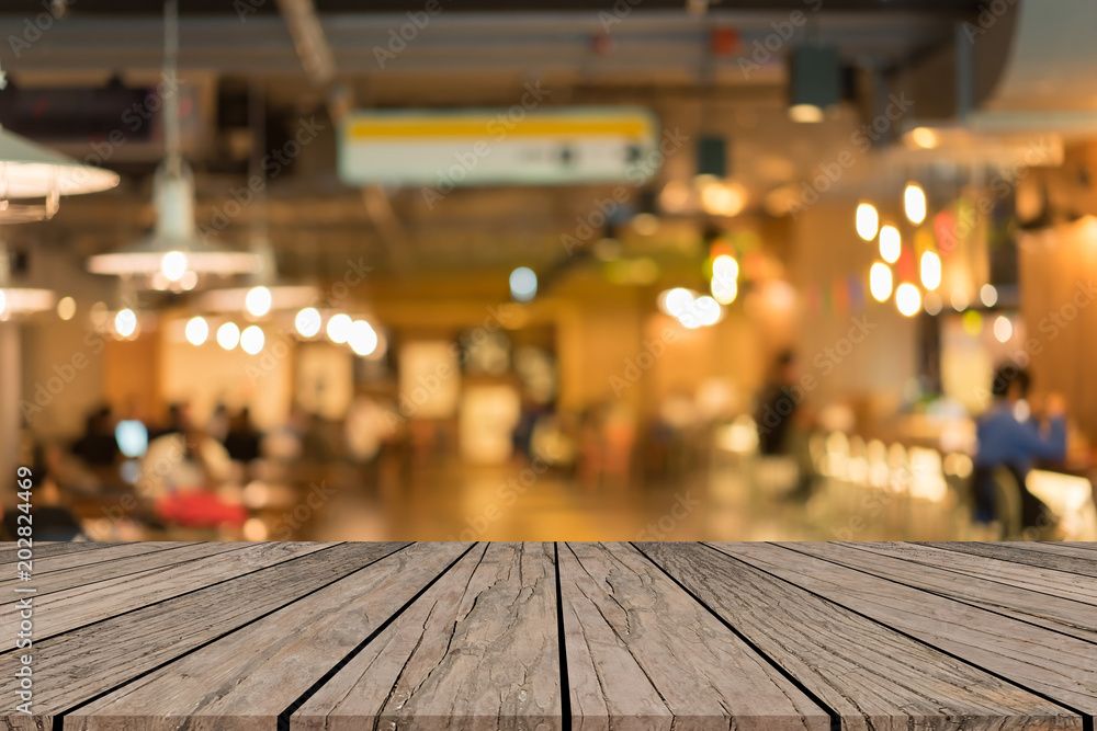 old vintage grungy brown wood panel tabletop with blurred restaurant bar cafe light color background for show,promote and advertise product on display