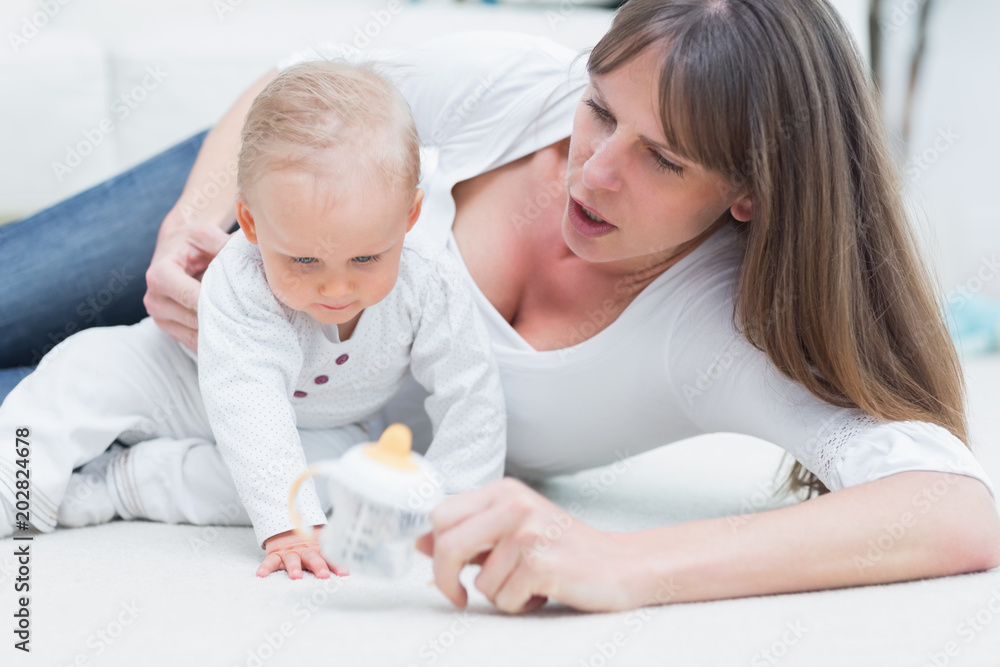 Baby and mother sitting on the floor Baby and mother sitting on the floor