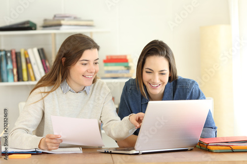 Two students learning together on line