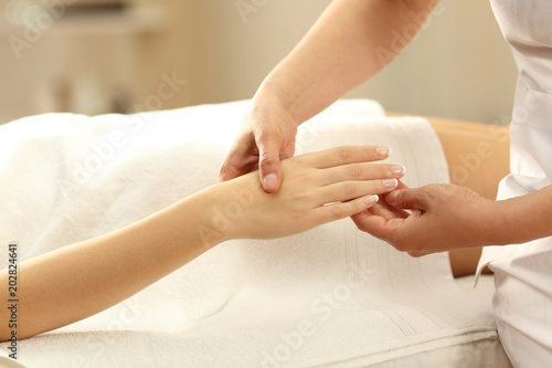 Closeup of a woman receiving a hand massage in a spa