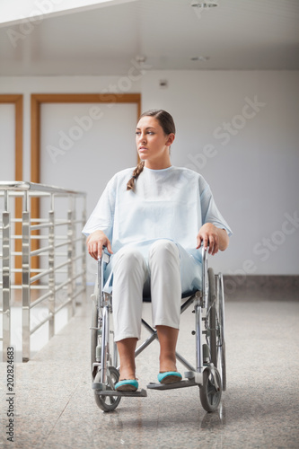 Front view of a thoughtful patient sitting on a wheelchair