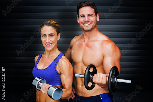 Bodybuilding couple against black background