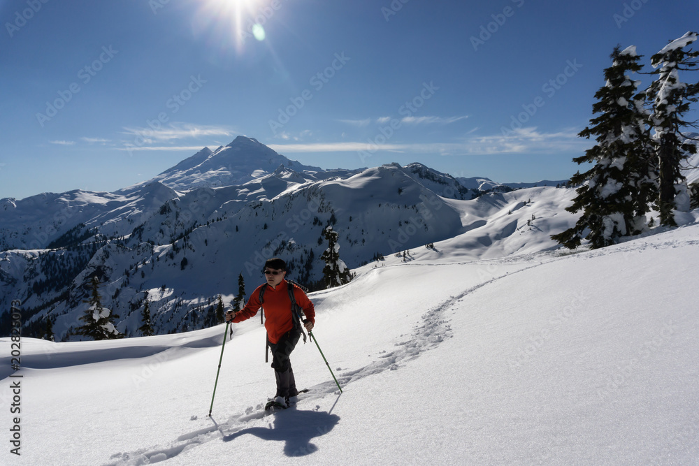 Adventurous man is snowshoeing in the alpine. Taken in Artist Point, Northeast of Seattle, Washington, United States of America.