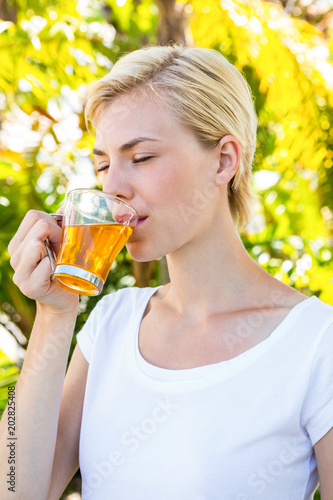 Attractive blonde woman drinking tea