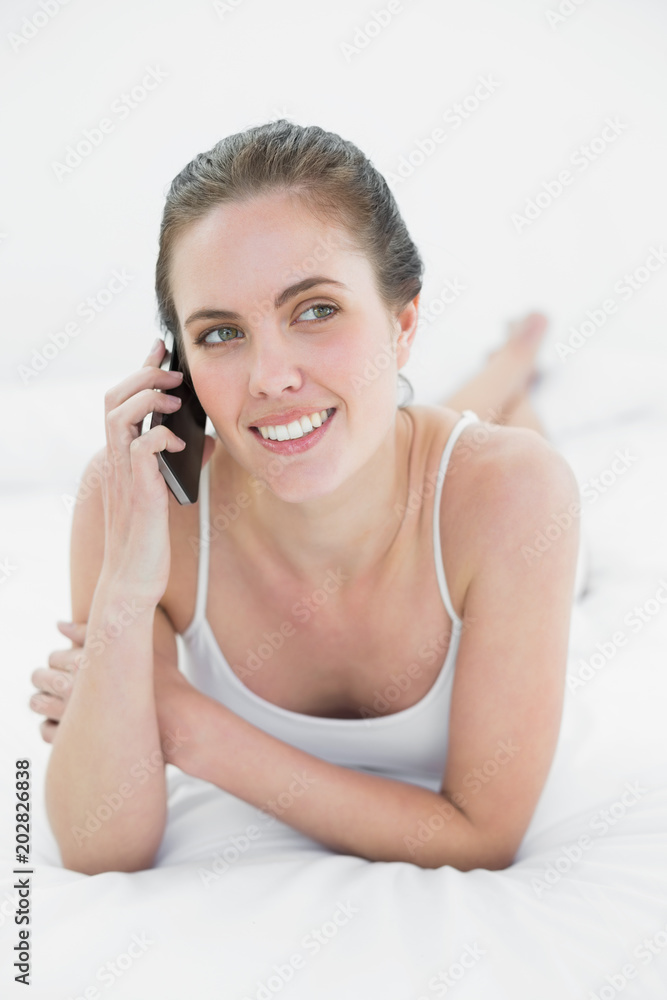 Woman using mobile phone in bed Woman using mobile phone in bed