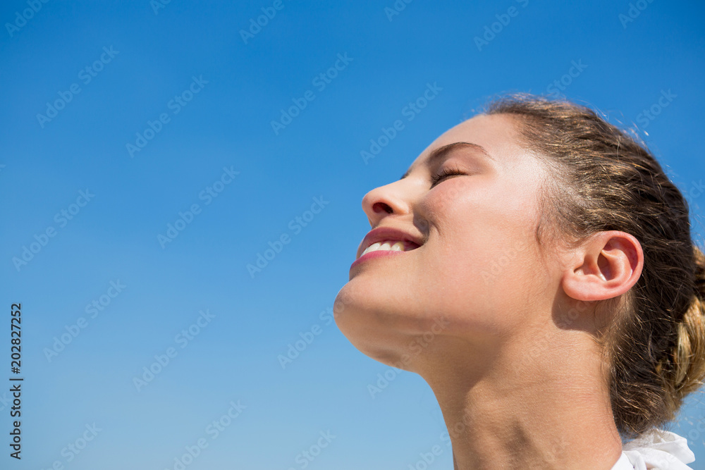 Low angle view of smiling woman with head back Low angle view of smiling woman with head back
