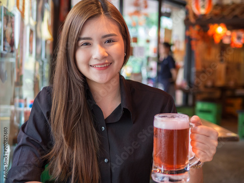 Young Asian woman enjoy drinking beer at japan resturant.