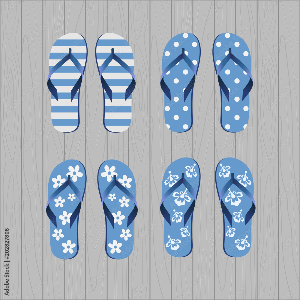 Four pair of different flip flops - blue white colors on grey wooden background Four pair of different flip flops - blue white colors on grey wooden background
