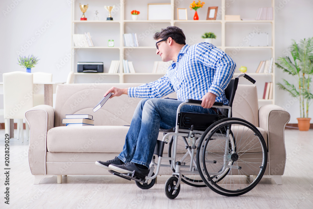 Young student on wheelchair in disability concept Young student on wheelchair in disability concept