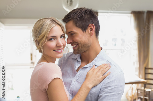 Happy loving young couple at home