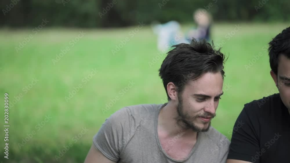 laughter, joy, friendship - three friends at the park watch the smartphone laugh laughter, joy, friendship - three friends at the park watch the smartphone laugh