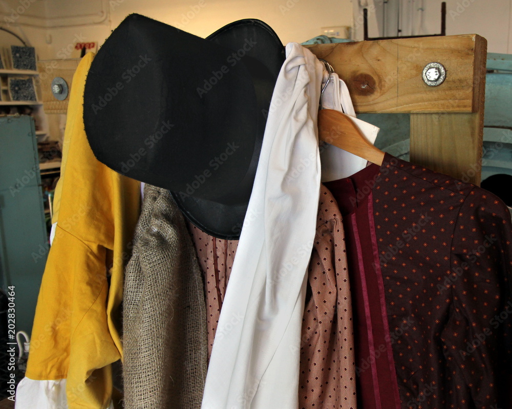 Old vintage clothes including top hat, smoking jacket, silk jacket, scarves  in yellow, white and crimson Stock Photo | Adobe Stock