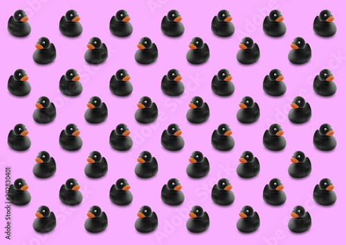 Fototapeta Naklejka Na Ścianę i Meble -  Seamless pattern of black rubber ducks in isolated pink background