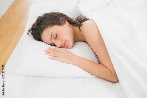 Pretty young woman sleeping in bed