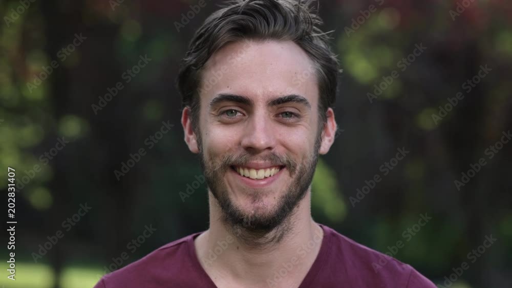beautiful young man at the park smiling at the camera beautiful young man at the park smiling at the camera