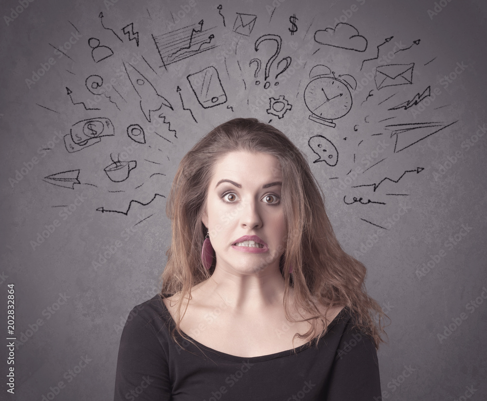 A dark brown haired pretty teenage girl with thoughts in her head illustrated by question mark, rocket, money, coffee, clock, email, social life icons drawn on the background wall concept. A dark brown haired pretty teenage girl with thoughts in her head illustrated by question mark, rocket, money, coffee, clock, email, social life icons drawn on the background wall concept.