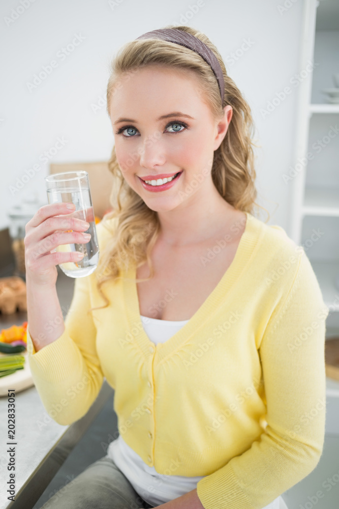 Happy cute blonde holding a glass of water Happy cute blonde holding a glass of water