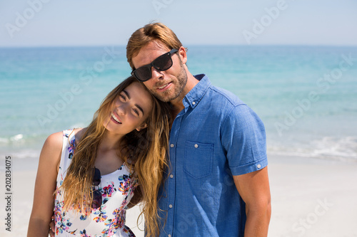 Young couple standing at on sunny day