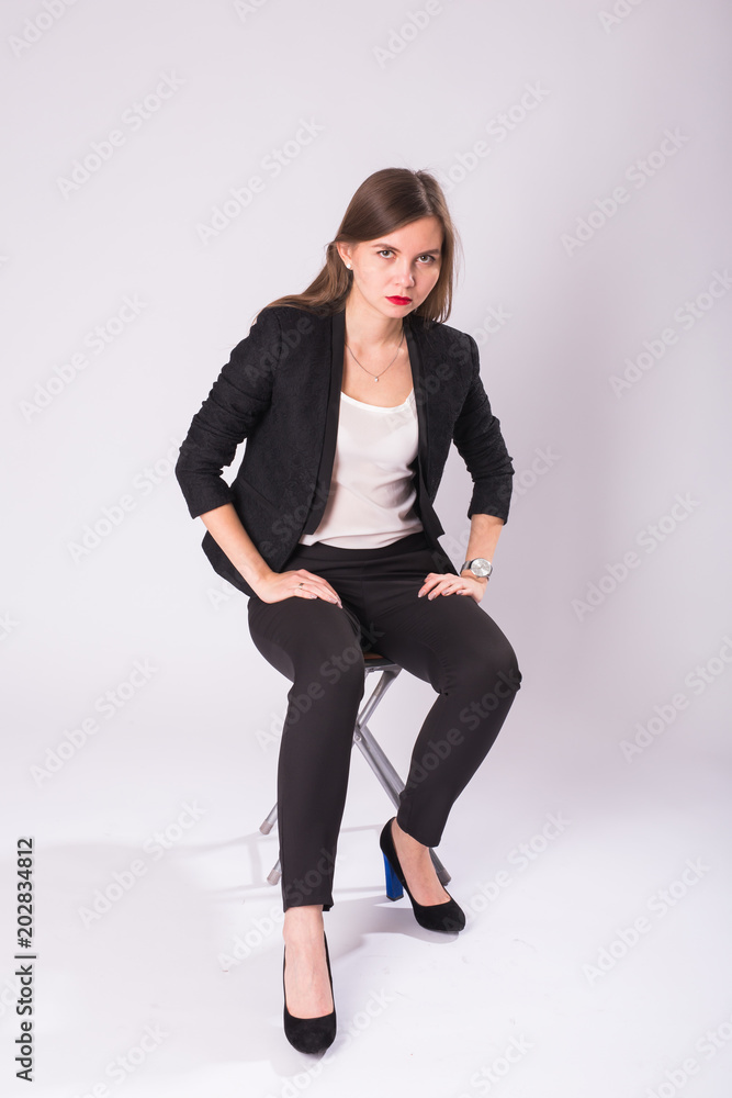 beautiful sexual businesswoman sitting on chair on white background. beautiful sexual businesswoman sitting on chair on white background.