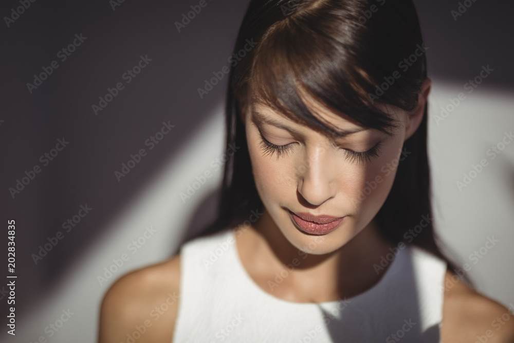 Thoughtful female executive looking down Thoughtful female executive looking down