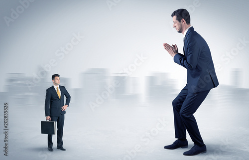 Giant businessman being afraid of small serious executor with suitcase 