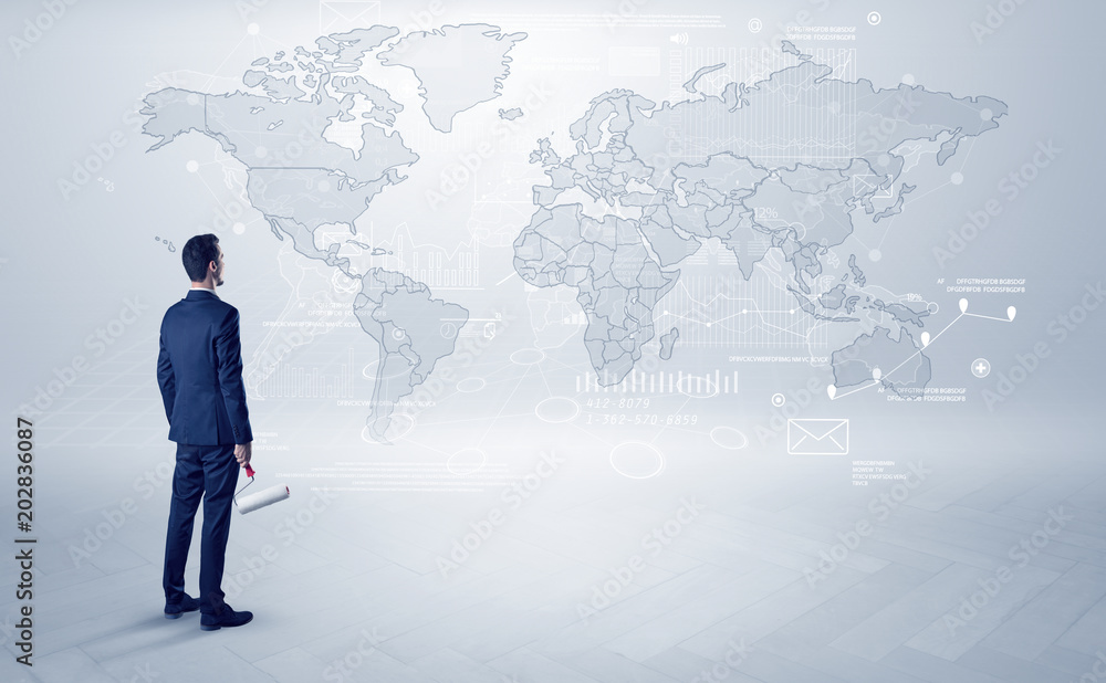 Businessman standing with his back and looking at a worldwide map with objects in his hand
Businessman standing with his back and looking at a worldwide map with objects in his hand
