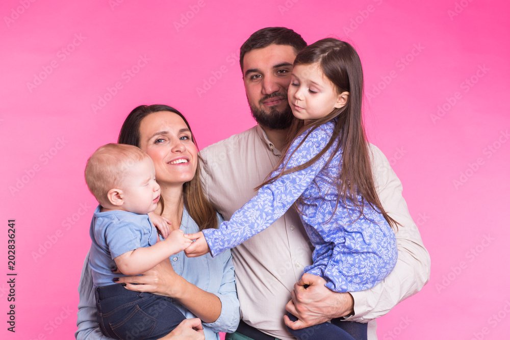 Portrait of Young Happy Mixed Race Family over pink background Portrait of Young Happy Mixed Race Family over pink background