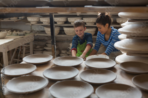 Female potter assisting a boy