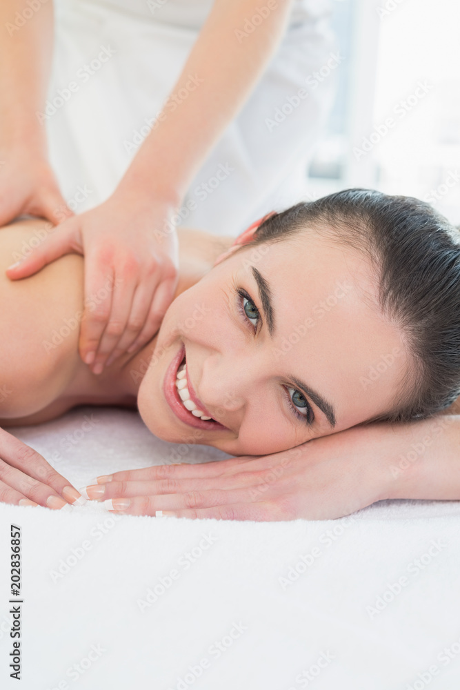 Beautiful woman enjoying shoulder massage at beauty spa Beautiful woman enjoying shoulder massage at beauty spa