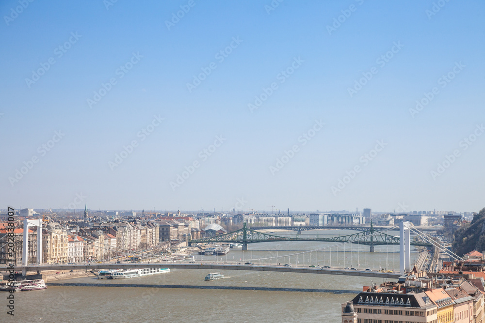Bridges of Erzsebet, Szabadsag and Petofi Hid over the Danube in Budapest, Hungary, seen from above, during a warm afternoon. Budapest is one of the main destinatinos of Central Europe.