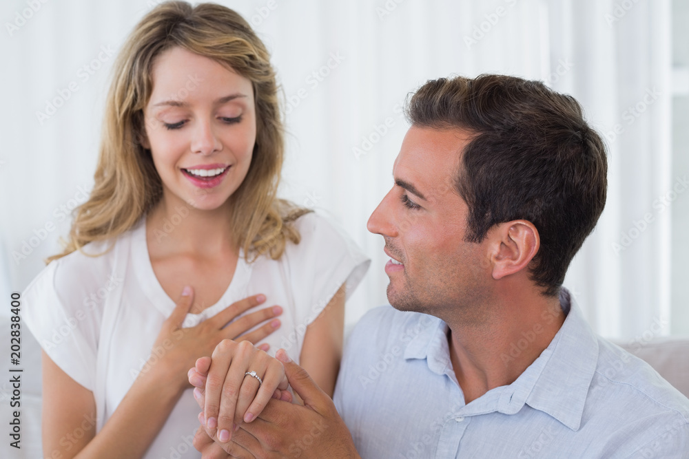 Cheerful woman looking at engagement ring besides man Cheerful woman looking at engagement ring besides man