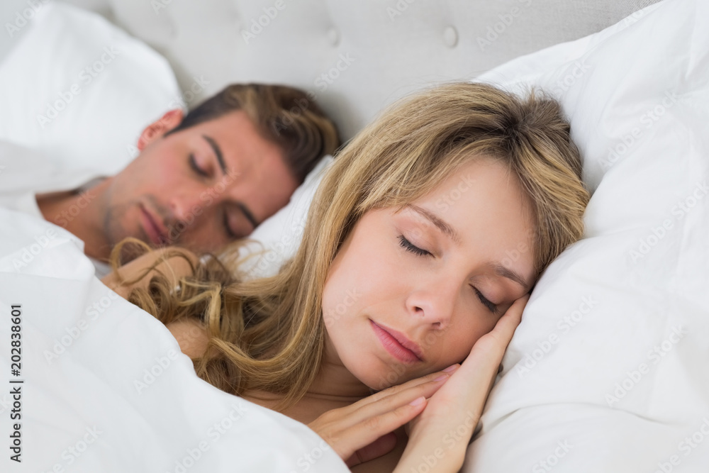 Relaxed couple sleeping together in bed Relaxed couple sleeping together in bed