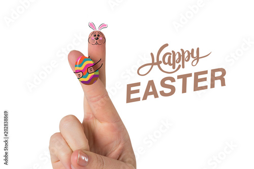 Fingers as easter bunny against happy easter graphic