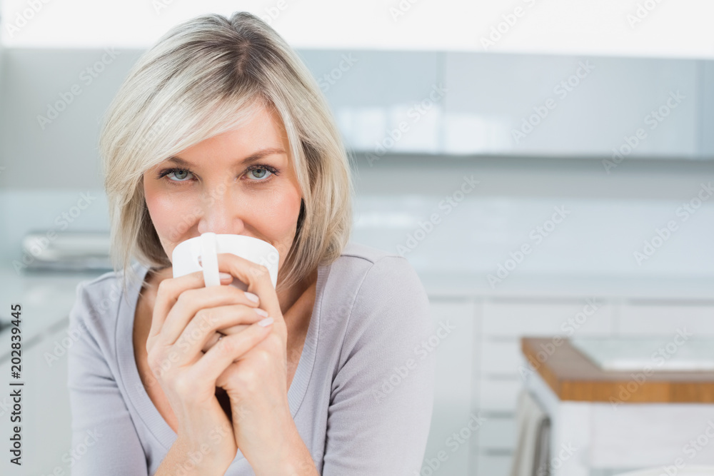 Casual young woman drinking coffee at home Casual young woman drinking coffee at home
