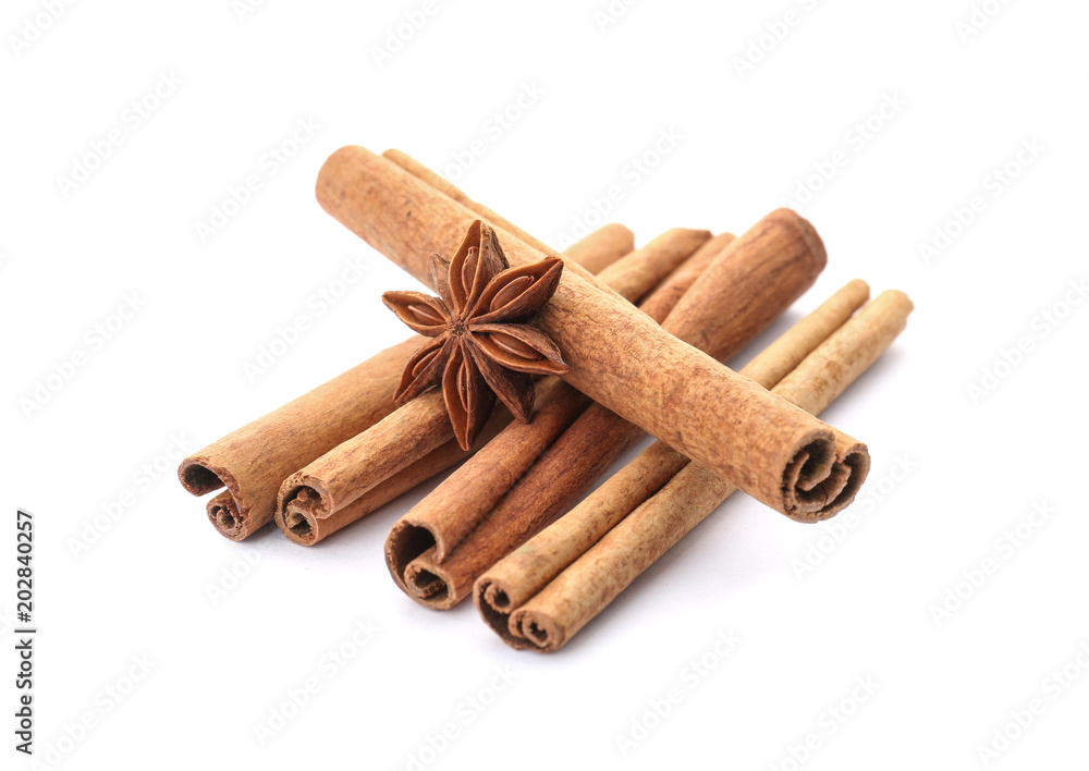 Aromatic cinnamon sticks and anise on white background