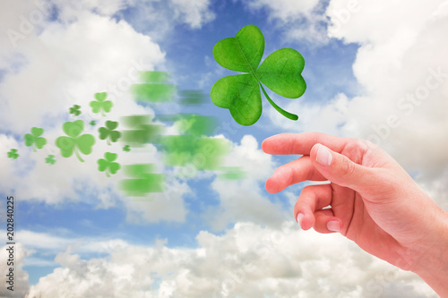 Shamrock against blue sky with white clouds © vectorfusionart
