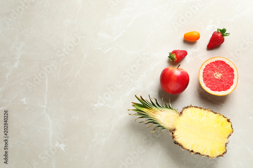 Flat lay composition with fresh fruits and strawberries on color background